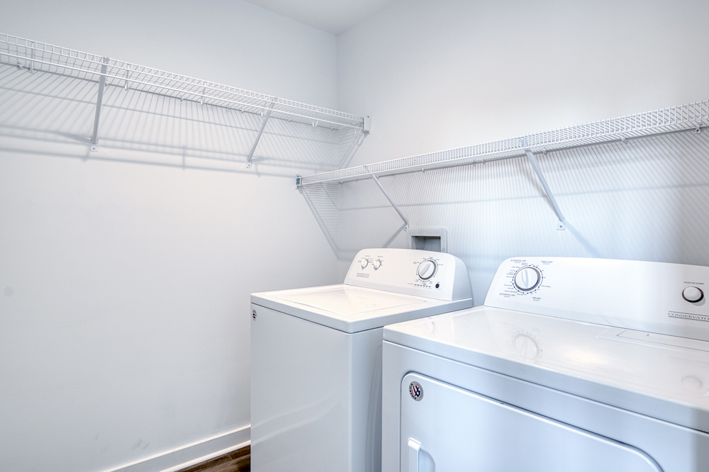 Two laundry machines in a clean white room